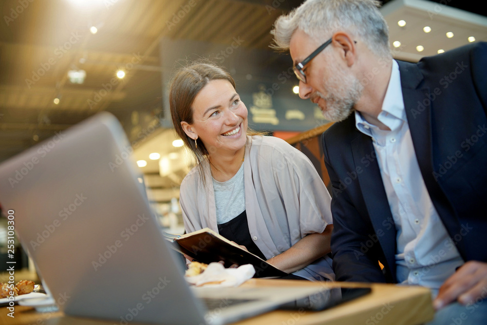 Informal meeting between salesman and manager in modern work space Informal meeting between salesman and manager in modern work space