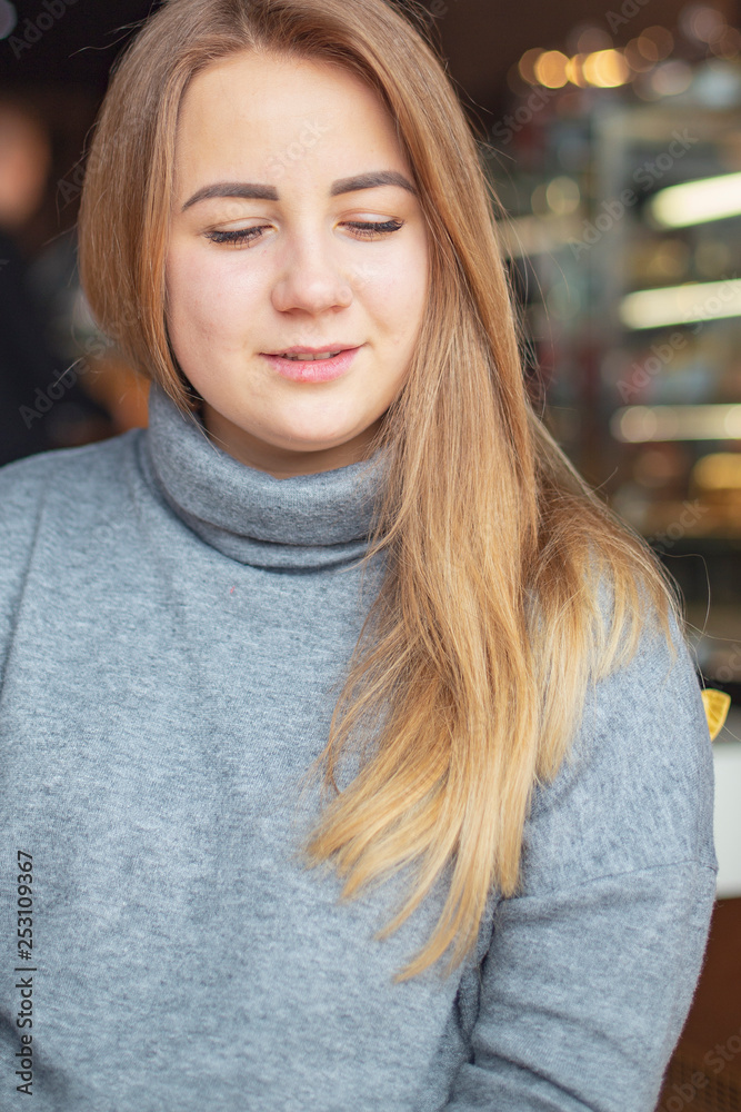 happy family, blonde mother and her beautiful and charismatic little son, the boy is having fun day in a cozy cafe. selective focus, noise effect