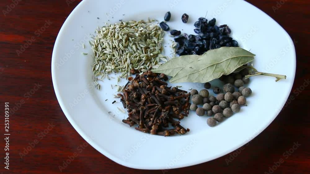 Spices on a plate. Bell pepper, bay leaf, fennel, red pepper, barberry, carnation. Spices on a plate. Bell pepper, bay leaf, fennel, red pepper, barberry, carnation.
