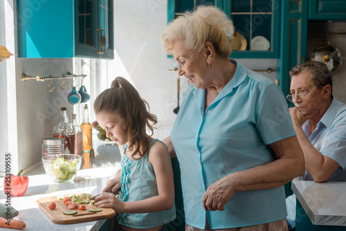 Granny teaches granddaughter to cook