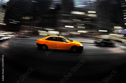 Fototapeta Naklejka Na Ścianę i Meble -  Taxi at Night in Busy City Street Dark Fast Driving Transportation Selective Color