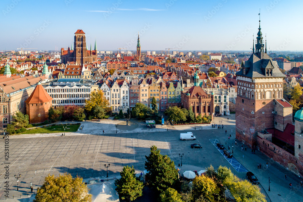 Fototapeta premium Gdansk, Poland. Old city skyline with Prison Tower, St Mary church, town hall tower, Golden Gate and Coal Market square (Targ Weglowy). Aerial view in sunset light