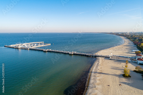 Wallpaper Mural Wooden pier with harbor, marina with yachts and beach in Sopot resort near Gdansk in Poland in sunset light. Aerial view. Torontodigital.ca