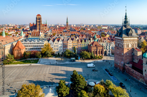 Gdansk, Poland. Old city skyline with Prison Tower, St Mary church, town hall tower, Golden Gate and Coal Market square (Targ Weglowy). Aerial view in sunset light