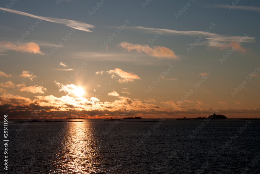 Sunset over the sea with a ship