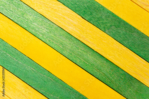 Yellow diagonal colored wooden background with green stripes