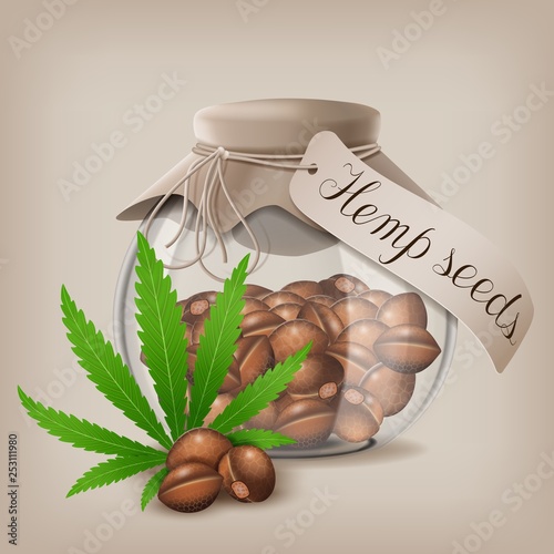Hemp seeds n a glass jar with hemp leaf.