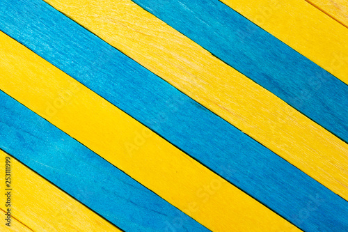 Yellow diagonal colored wooden background with aquamarine stripes