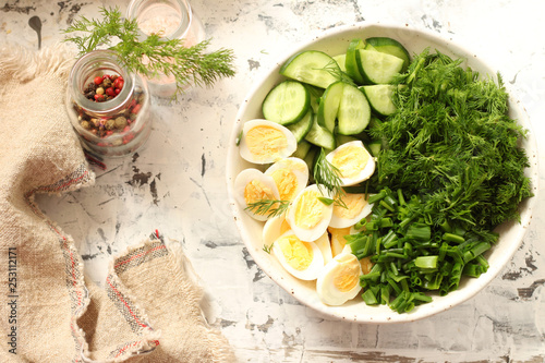 Spring salad with cucumbers, quail eggs and herbs