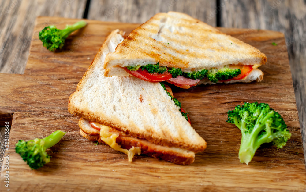 Broccoli cheese sandwiches on wooden cutting board, on wooden table Broccoli cheese sandwiches on wooden cutting board, on wooden table