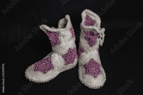 knitted Violet slippers on a black background
