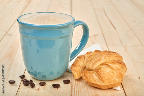 coffee with croissnt on a wooden table photo