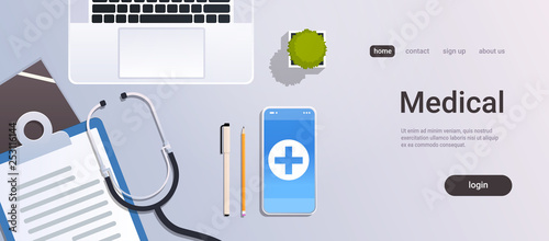 hospital worker table online mobile app top angle view doctor workplace desktop with laptop smartphone stethoscope and clipboard office stuff copy space horizontal