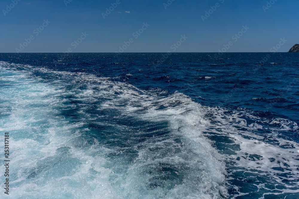 Obraz premium Italy, Cinque Terre, Monterosso, a man riding a wave in the ocean