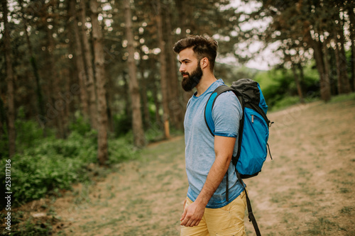 Active healthy man hiking in beautiful forest