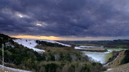 Snowy vsunsetacross the Meon Valley towards Old Winchester Hill, South Downs National Park, Hampshire, UK