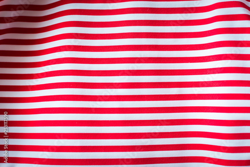Striped red and white striped fabric, background.