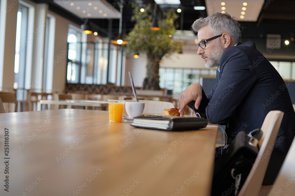 Businessman working in modern office cafeteria Businessman working in modern office cafeteria