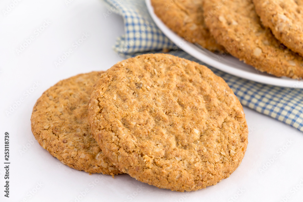 Homemade shortbread cookies made of oatmeal are pile on white plate on the cloth background. Concept food healthy snack for enjoy in holiday. Homemade shortbread cookies made of oatmeal are pile on white plate on the cloth background. Concept food healthy snack for enjoy in holiday.