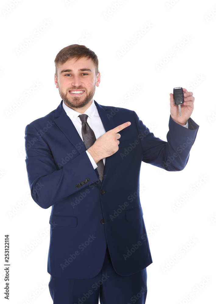 Happy young businessman with car key on white background Happy young businessman with car key on white background