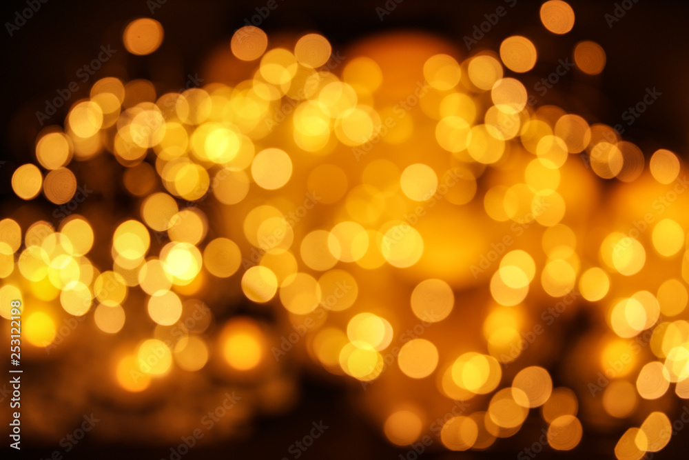 Gold glitter with bokeh effect on dark background Gold glitter with bokeh effect on dark background