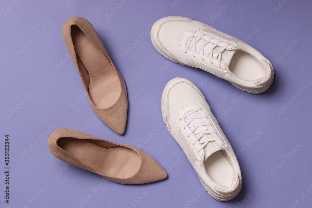 white sneakers and high heel shoes on a colored background top view. Women's shoes. Classic and sport shoes. white sneakers and high heel shoes on a colored background top view. Women's shoes. Classic and sport shoes.