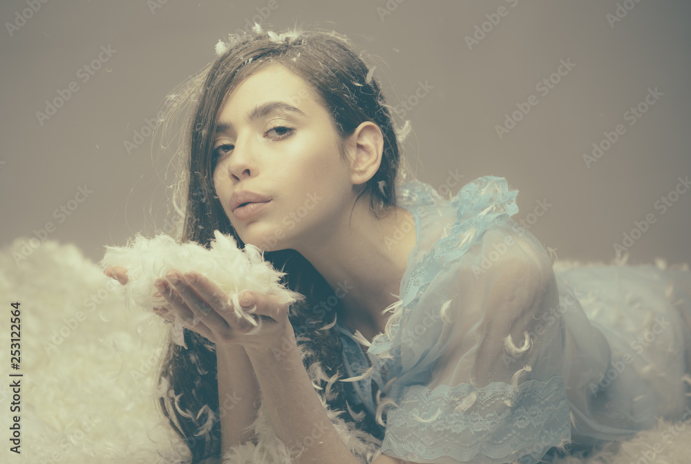 Feeling cozy. Cute girl relaxing on feather bed pillow and mattress