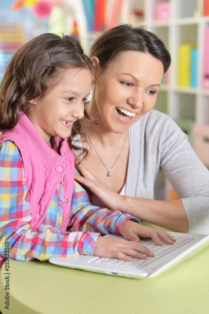 Portrait of mother and daughter using laptop Portrait of mother and daughter using laptop