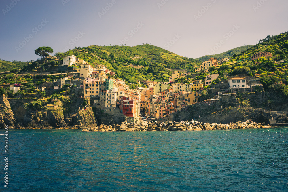 The cityscape of Riomaggiore viewed from the sea, Cinque Terre, Italy, Riviera The cityscape of Riomaggiore viewed from the sea, Cinque Terre, Italy, Riviera