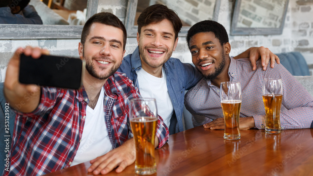 Friends making selfie and smiling, resting at pub Friends making selfie and smiling, resting at pub