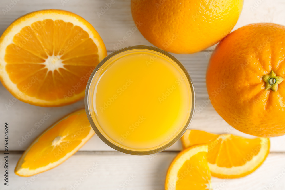 Flat lay composition with orange juice and fresh fruit on wooden background Flat lay composition with orange juice and fresh fruit on wooden background