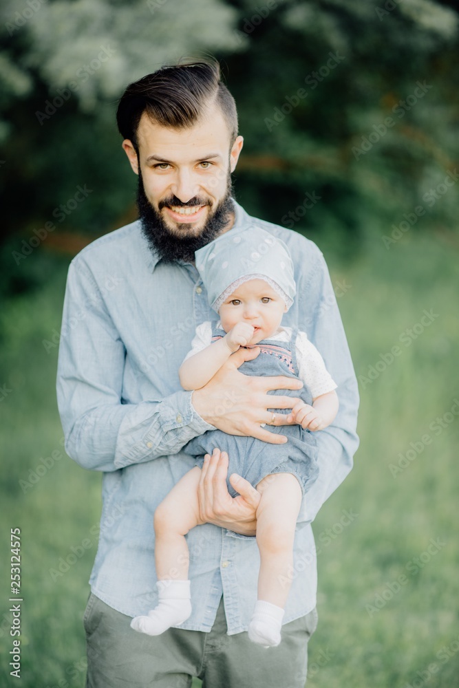 portrait of father and child. A stylish father with a beard keeps on his arms a child, a little girl, they embrace and smile, rejoice and have fun. Happy Father's Day portrait of father and child. A stylish father with a beard keeps on his arms a child, a little girl, they embrace and smile, rejoice and have fun. Happy Father's Day