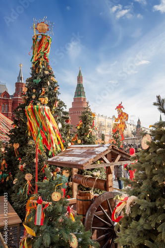 Photography Manezhnaya Square in the center of Moscow, decorated with festive symbols of the Shrovetide in the form of the sun, colorful ribbons and garlands