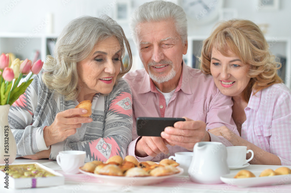 Portrait of happy senior people with smartphone drinking tea Portrait of happy senior people with smartphone drinking tea