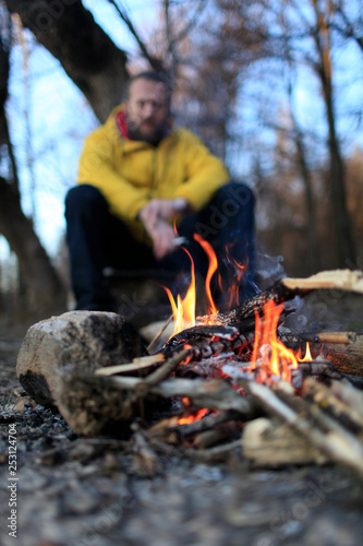 Person in the spring forest near the fire