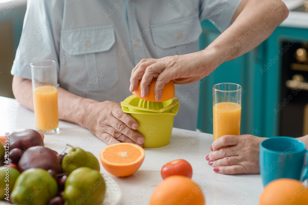 Old man squeezing an orange Old man squeezing an orange