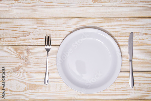 Food concept,  empty white plate on a wooden background.