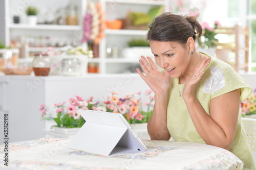 Portrait of cute young woman using digital tablet