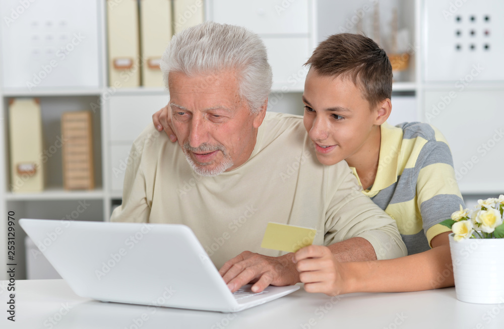 Emotional boy and grandfather with a laptop Emotional boy and grandfather with a laptop