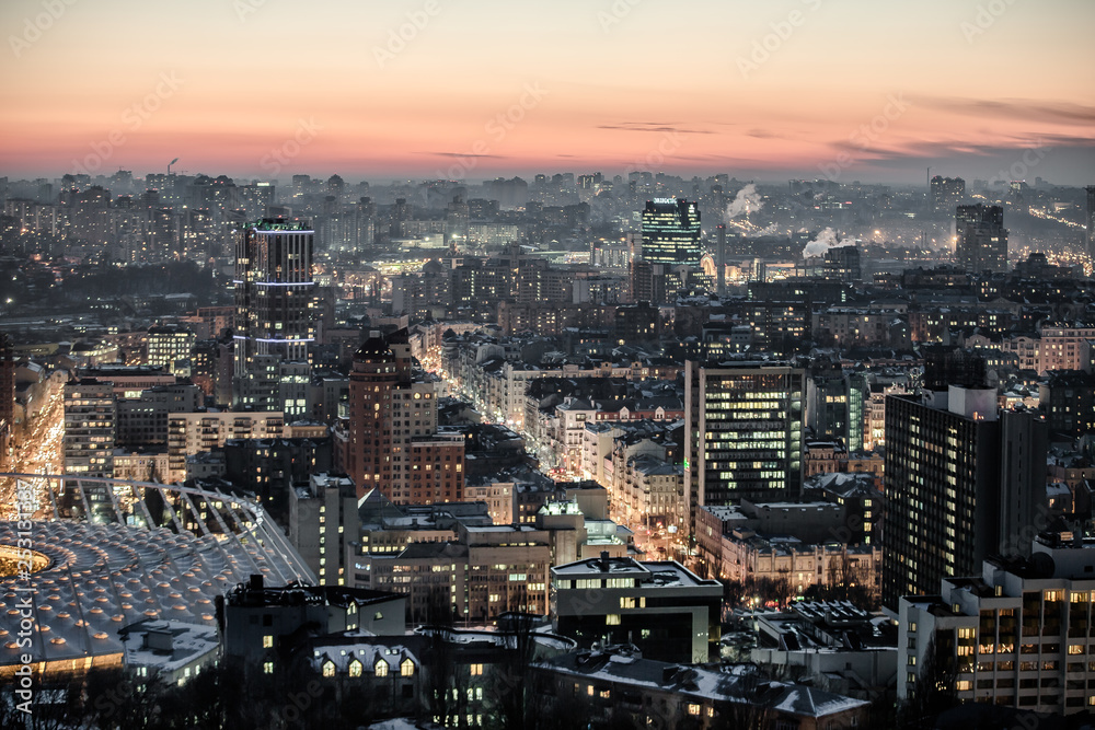 Evening city, buildings, transport, production in Kiev