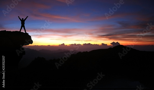 silhouette of man on top of mountain at sunset © SINNBILD Design