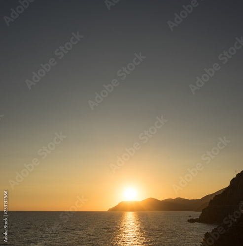 Golden sunset at the cliff at the Italian Riviera in the Village of Riomaggiore, Cinque Terre, Italy © SkandaRamana