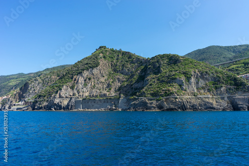 Italy Cinque Terre Riomaggiore  a large body of water with a mountain in the background