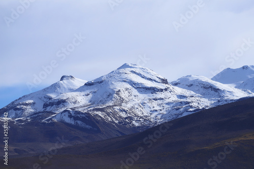 View of the Andes Mountains and volcanoes of northern Chile with snow on the summit located near El Tatio geyser field, Atacama Desert, Chile