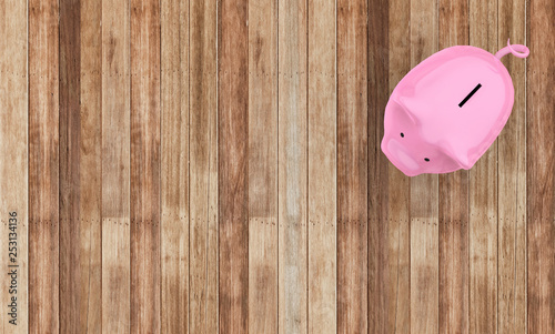 Piggy Saving Bank on Wood Background