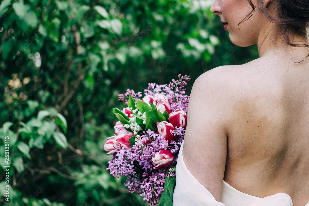 Wedding ceremony. Bride holds wedding bouquet from flowers. Girl is dressed in white lace wedding dress. Wedding ceremony. Bride holds wedding bouquet from flowers. Girl is dressed in white lace wedding dress.