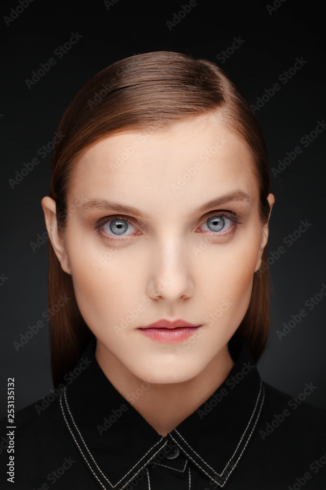 Close-up portrait of a beautiful model with clean makeup and collected hair, photographed in a photo studio Close-up portrait of a beautiful model with clean makeup and collected hair, photographed in a photo studio