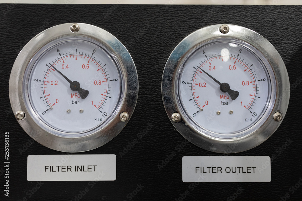 Two pressure gauges on a black background close-up Two pressure gauges on a black background close-up