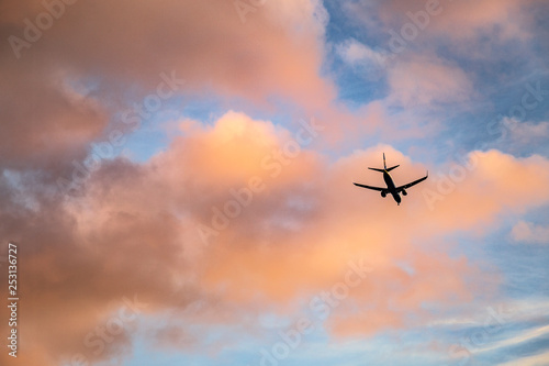 Plane flying at sunset