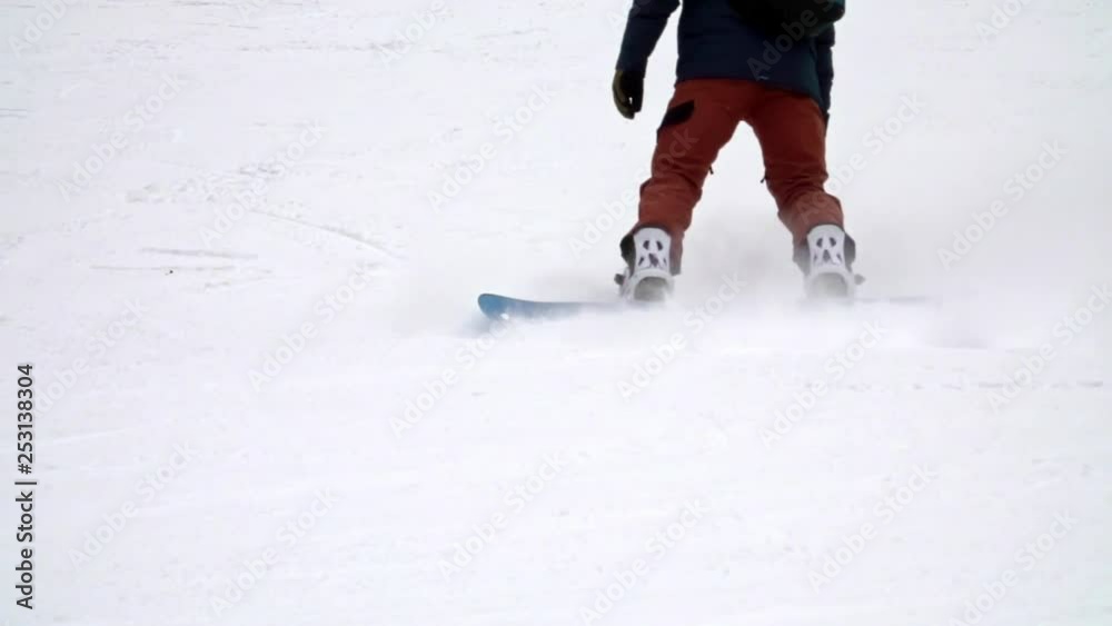 Skier in mountains, prepared piste. Slow motion. Focus on the legs Skier in mountains, prepared piste. Slow motion. Focus on the legs